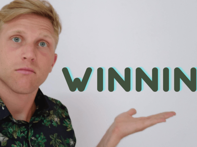 incredibly handsome guy who likes alt texts holding up the word "winning!" on his hand